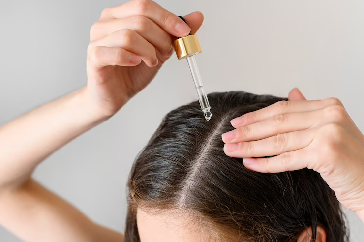 close-up-woman-applying-serum-hair_23-2148547394