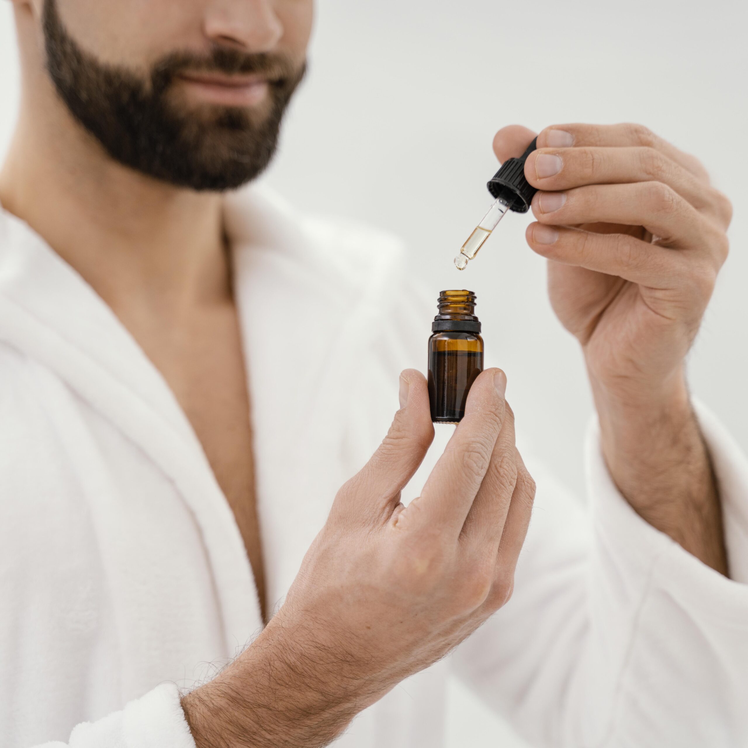 man-using-natural-oils-his-face