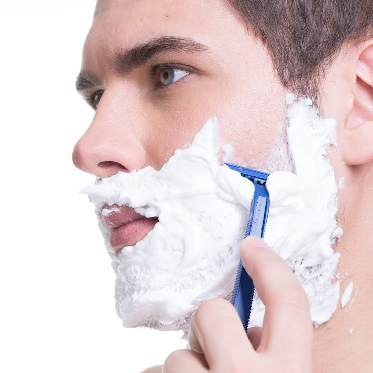 young-man-shaving-beard-with-razor_186202-8993